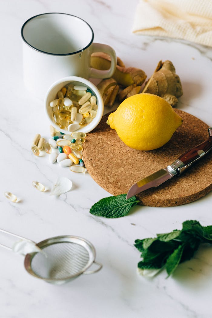 creative-03 A flat lay of natural ingredients and supplements featuring lemon, ginger, and pills.